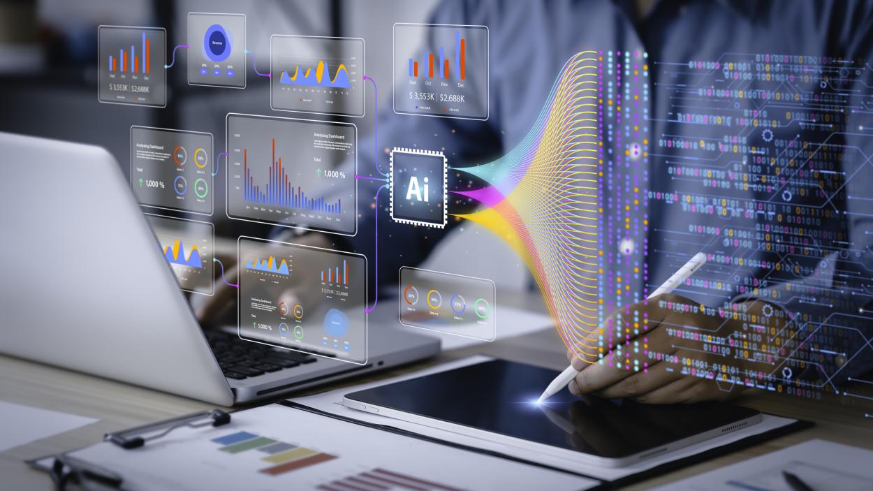 AI and graphs overlay over someone working on a laptop and iPad