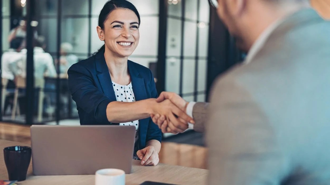woman shaking hands at a meeting
