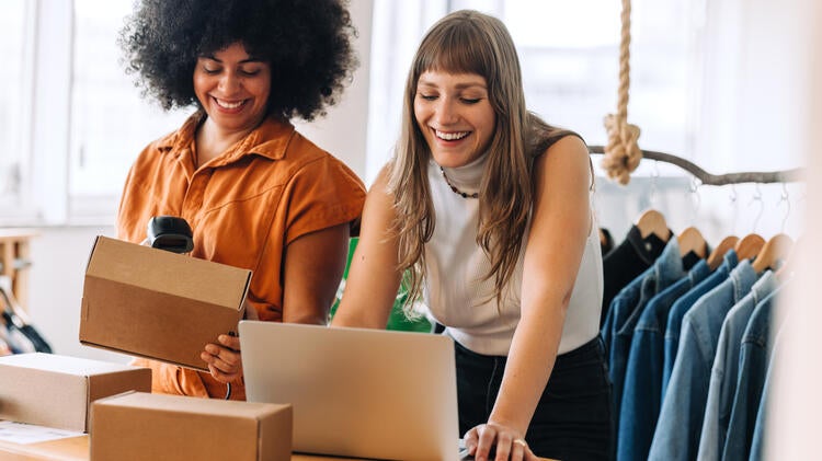 women packaging clothes to ship